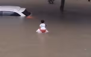 泪目！郑州暴雨中爸爸将儿子扛在肩头 趟着过胸的深水中缓慢前行