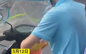 街头等红灯时父亲打开女儿的奖状欣赏，又小心翼翼地收起来