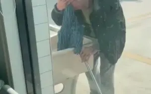 女子看见窗外老人用拖把擦头