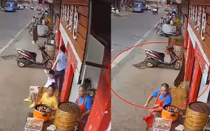 监控曝光！街头突刮大风男孩被拉到店内 下一秒木板直接砸中座位