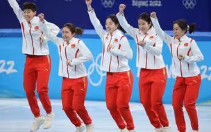 中国队短道速滑女子3000米接力摘铜，中国姑娘们跳上领奖台，手举金墩墩，向观众们微笑示意。